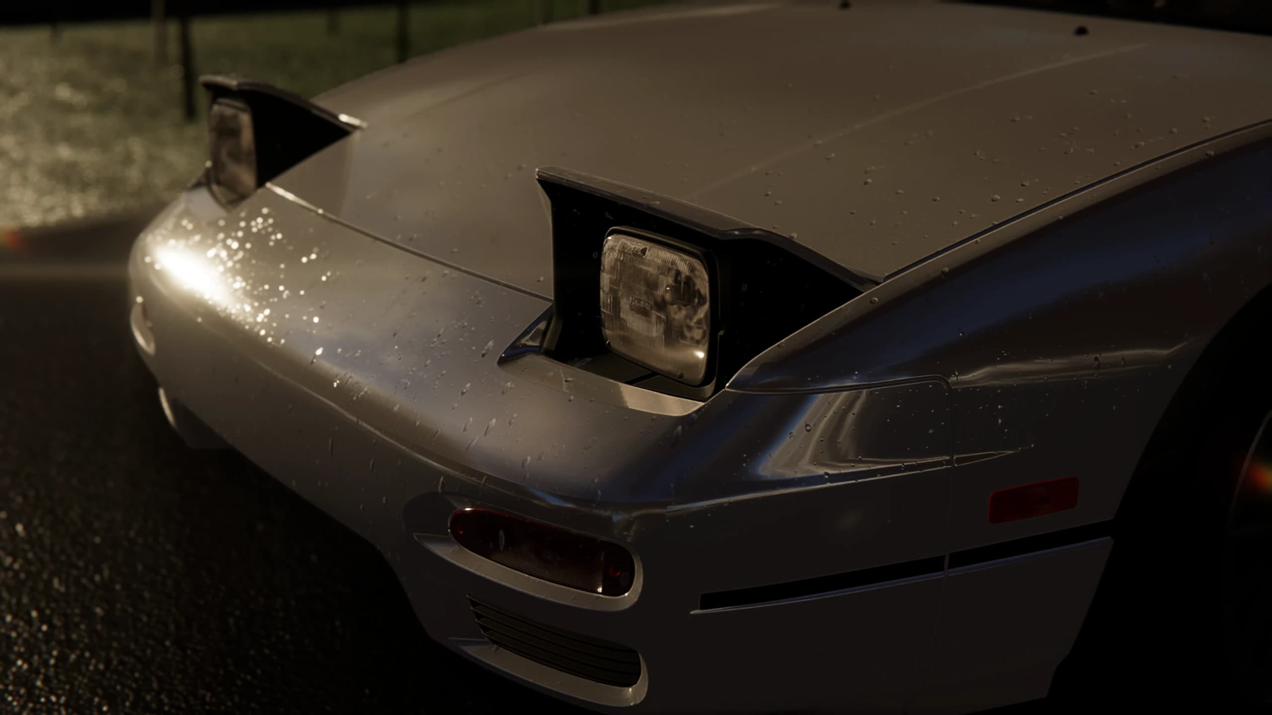 Front of a silver coupe with rain-covered pop-up headlights
