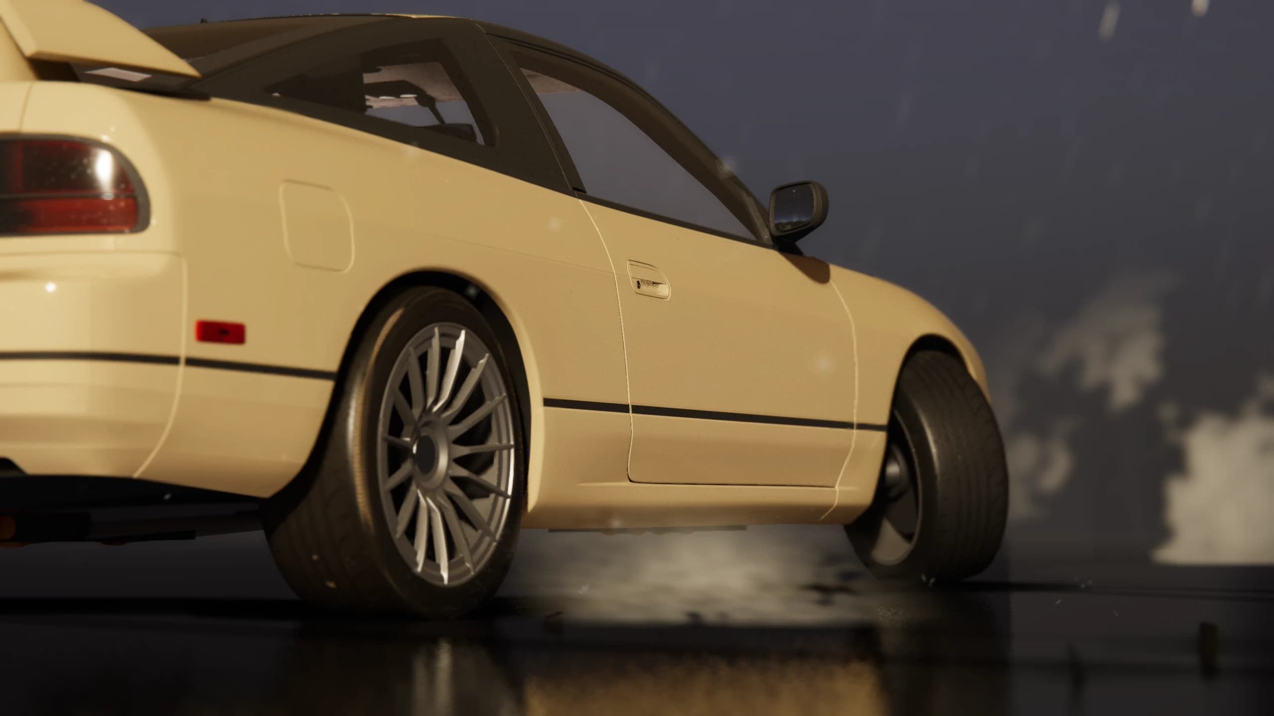 Low side view of a cream coupe with its front wheel turned
