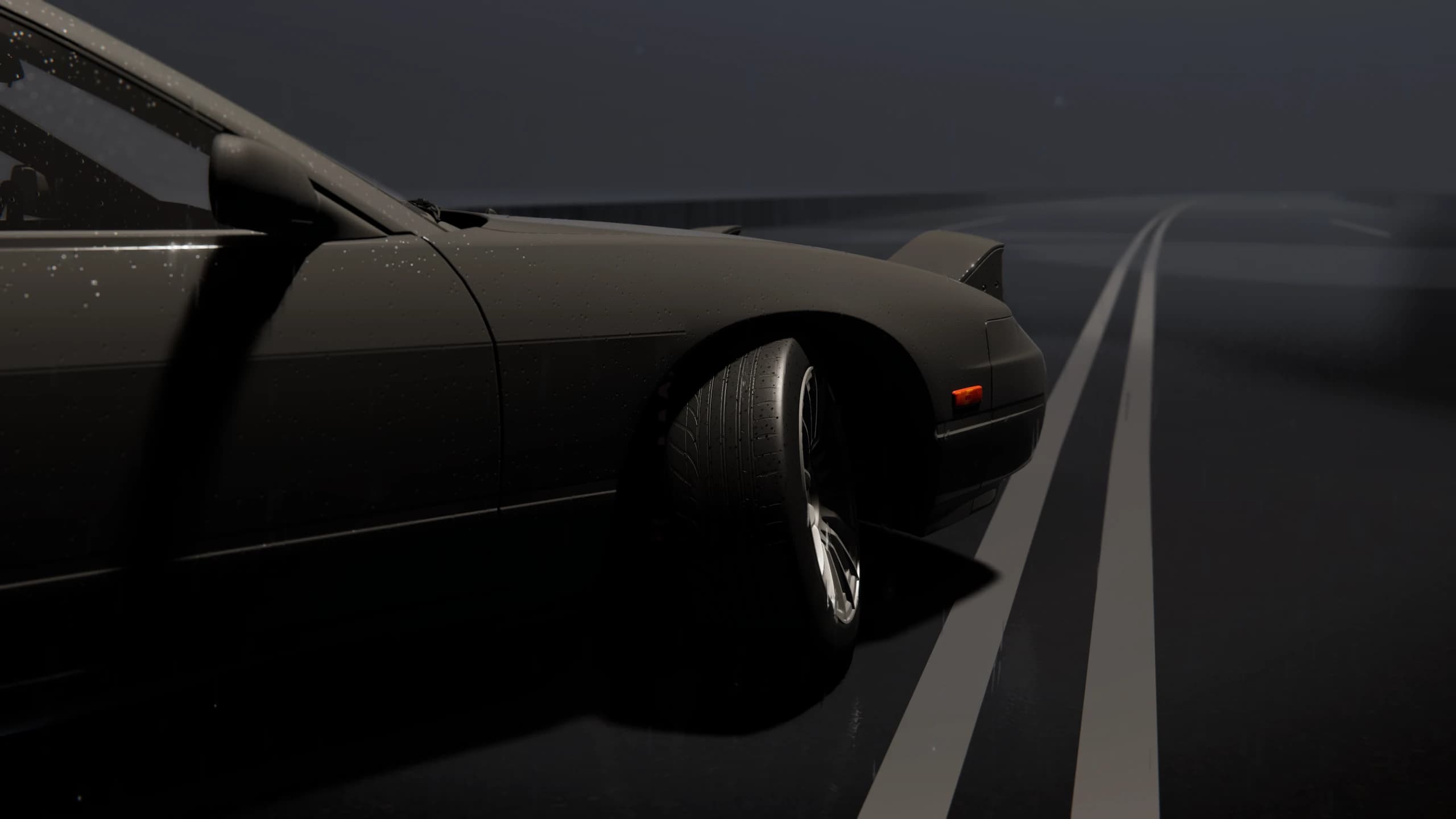 Front tyre turned across lane markings on a wet road