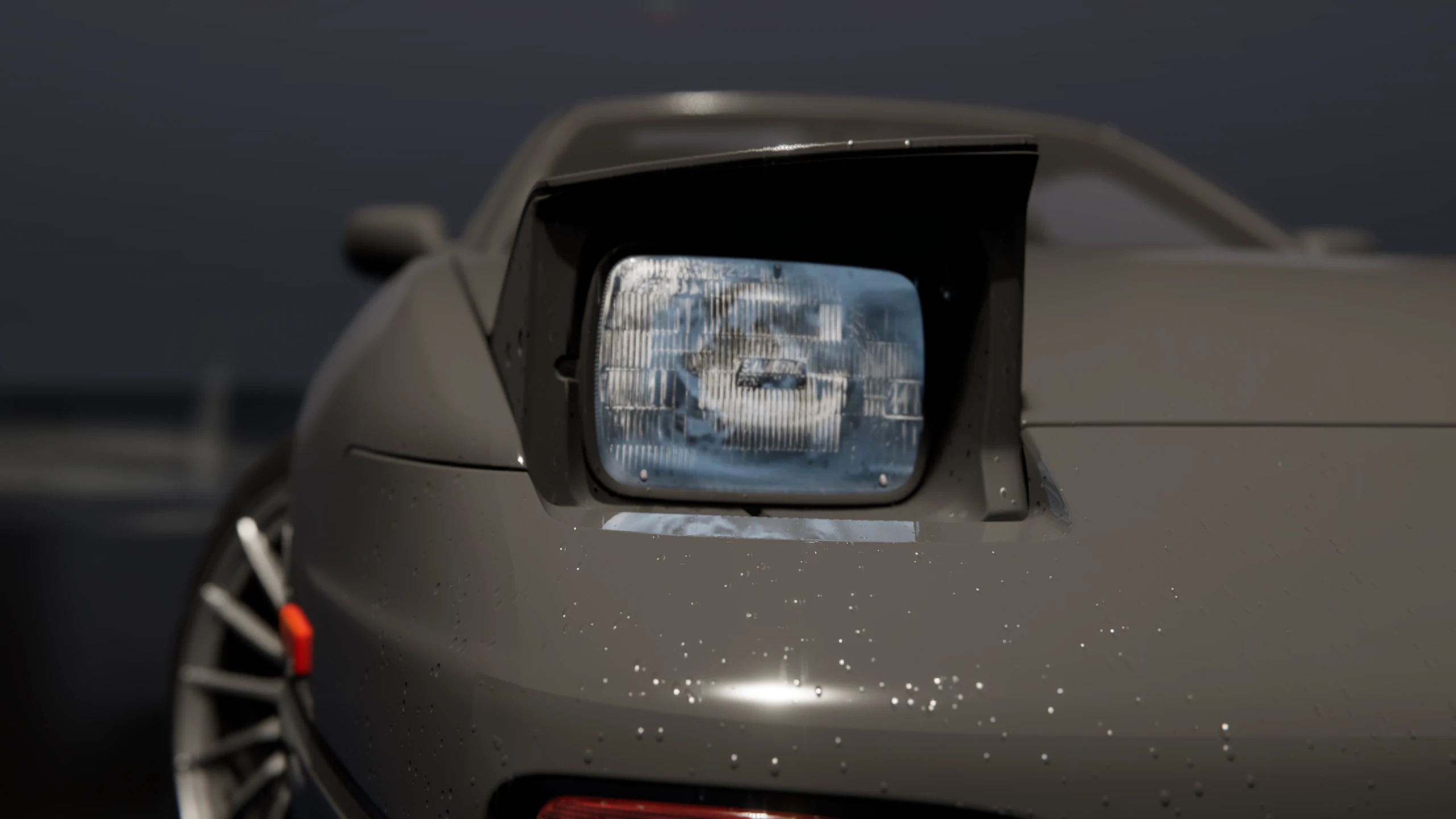 Rain-covered pop-up headlight shown in close detail