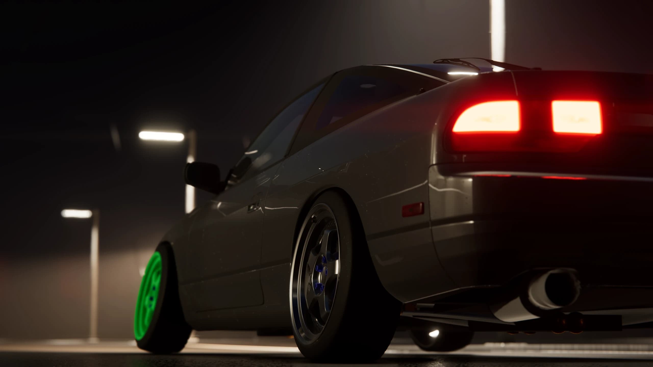 Low rear view of a coupe beneath road lights at night
