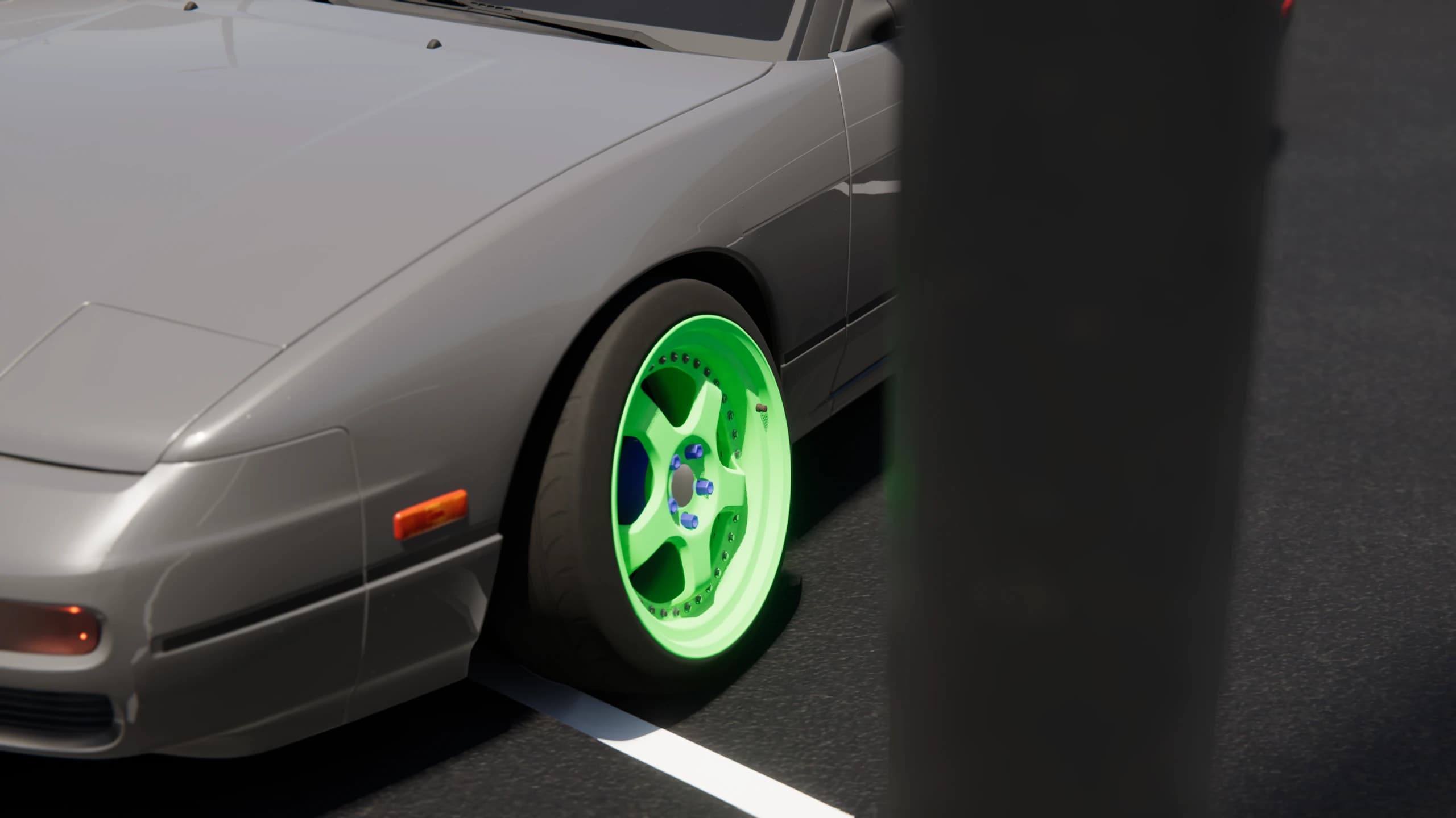 Close view of a coupe fitted with a bright green front wheel