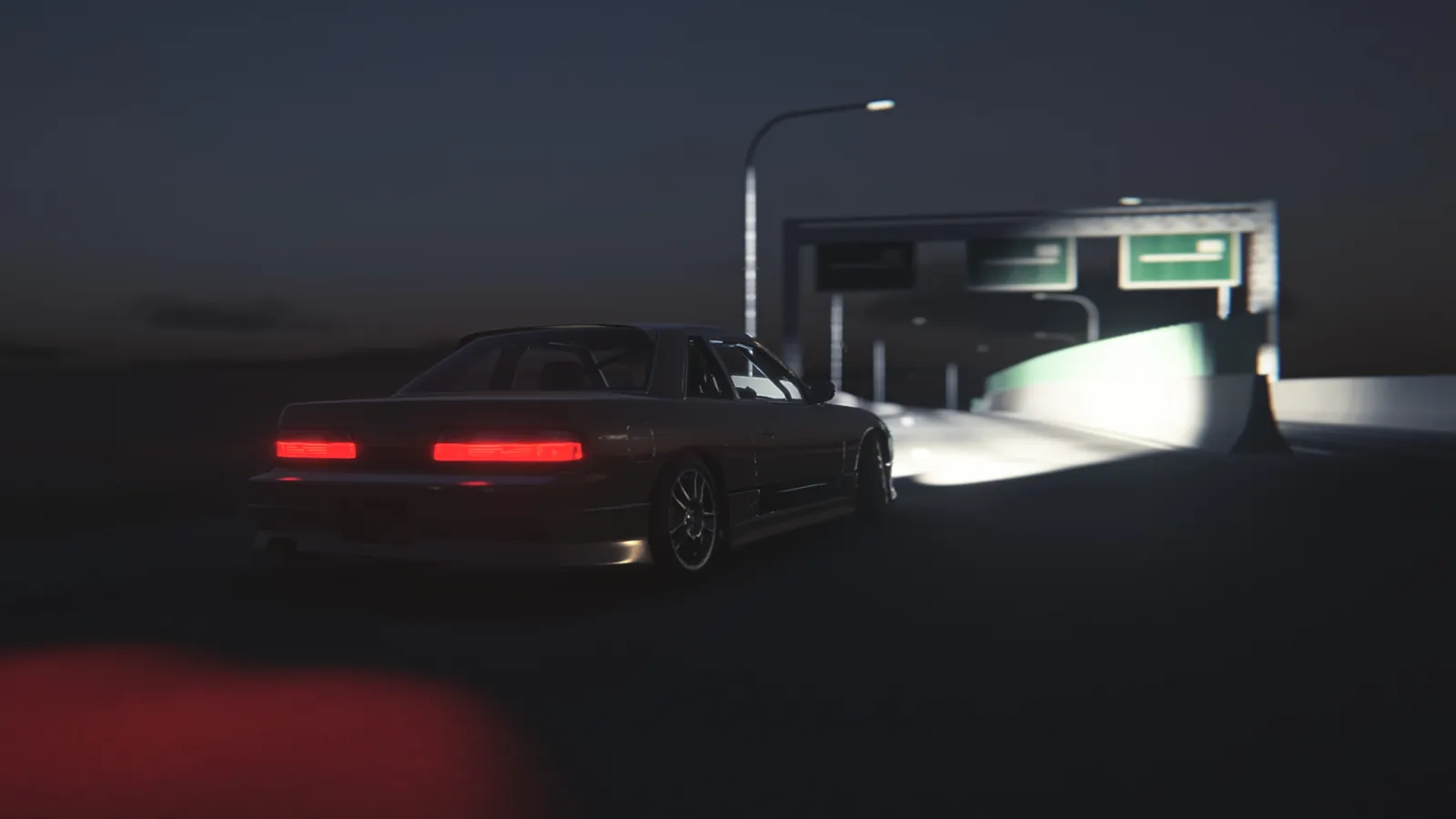 Rear view of a coupe approaching a gantry with green road signs under a street lamp at night