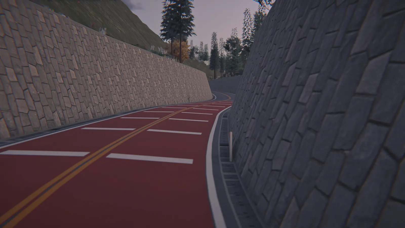 Red road curving between two stone retaining walls